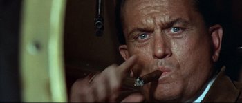 Movie still from “Duck, You Sucker!” (1971), directed by Sergio Leone – A person smoking a cigar; Close Up shot, Low angle