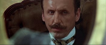 Movie still from “Duck, You Sucker!” (1971), directed by Sergio Leone – A person wearing a suit and tie; Close Up shot, Low angle