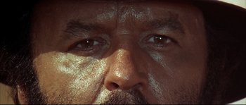 Movie still from “Duck, You Sucker!” (1971), directed by Sergio Leone – A man's eyes and a mustache; Extreme Close Up shot, Low angle