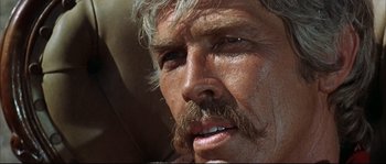 Movie still from “Duck, You Sucker!” (1971), directed by Sergio Leone – An older man with a mustache and a beard; Close Up shot, Low angle