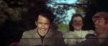 Movie still from “Duck, You Sucker!” (1971), directed by Sergio Leone – A man and a woman are smiling for the camera; Close Up shot, Low angle