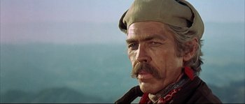 Movie still from “Duck, You Sucker!” (1971), directed by Sergio Leone – An older man with a mustache and a hat; Close Up shot, Low angle