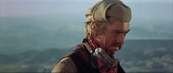 Movie still from “Duck, You Sucker!” (1971), directed by Sergio Leone – An older man wearing a hat and ear muffs; Close Up shot, Low angle