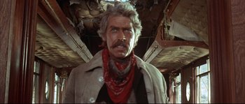 Movie still from “Duck, You Sucker!” (1971), directed by Sergio Leone – An older man wearing a red bandanna and a white jacket; Close Up shot, Low angle
