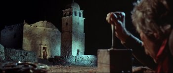 Movie still from “Duck, You Sucker!” (1971), directed by Sergio Leone – A very tall tower with a clock on it's side; Extreme Wide shot, Low angle