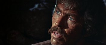 Movie still from “Duck, You Sucker!” (1971), directed by Sergio Leone – A person with a beard and mustaches; Close Up shot, Over the shoulder angle