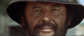 Movie still from “Duck, You Sucker!” (1971), directed by Sergio Leone – A man with a beard wearing a cowboy hat; Extreme Close Up shot, Low angle