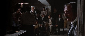 Movie still from “Duck, You Sucker!” (1971), directed by Sergio Leone – A group of men sitting in a room; Wide shot, Over the shoulder angle