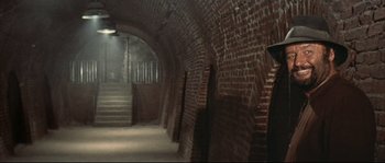 Movie still from “Duck, You Sucker!” (1971), directed by Sergio Leone – A brick tunnel with a staircase leading up to it; Wide shot, High angle