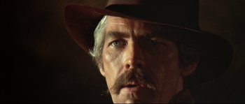 Movie still from “Duck, You Sucker!” (1971), directed by Sergio Leone – A person wearing a cowboy hat; Close Up shot, Low angle