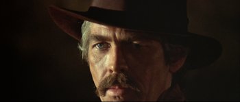 Movie still from “Duck, You Sucker!” (1971), directed by Sergio Leone – A person wearing a cowboy hat; Close Up shot, Low angle