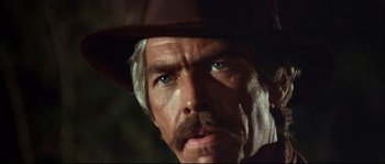 Movie still from “Duck, You Sucker!” (1971), directed by Sergio Leone – A person wearing a cowboy hat; Close Up shot, Low angle