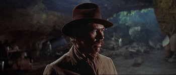 Movie still from “Duck, You Sucker!” (1971), directed by Sergio Leone – A person wearing a hat and a suit; Close Up shot, Low angle