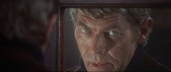 Movie still from “Duck, You Sucker!” (1971), directed by Sergio Leone – A person looking into a mirror; Close Up shot, Over the shoulder angle