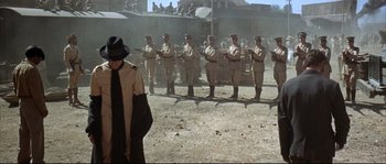 Movie still from “Duck, You Sucker!” (1971), directed by Sergio Leone – A group of men standing in front of each other; Wide shot, High angle