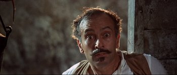 Movie still from “Duck, You Sucker!” (1971), directed by Sergio Leone – A person with a beard and a mustache; Close Up shot, Low angle