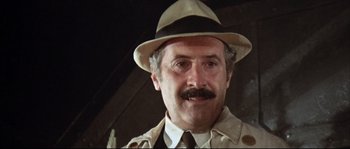 Movie still from “Duck, You Sucker!” (1971), directed by Sergio Leone – An older man wearing a hat and a trench coat; Close Up shot, Low angle