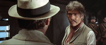 Movie still from “Duck, You Sucker!” (1971), directed by Sergio Leone – A man is looking at himself in the mirror; Close Up shot, Over the shoulder angle