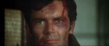 Movie still from “Duck, You Sucker!” (1971), directed by Sergio Leone – A man's face with blood on his face; Close Up shot, High angle