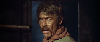 Movie still from “Duck, You Sucker!” (1971), directed by Sergio Leone – A man with long hair and a mustache; Close Up shot, Low angle