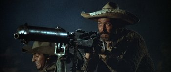 Movie still from “Duck, You Sucker!” (1971), directed by Sergio Leone – A man in a cowboy hat is holding a rifle; Medium shot, Low angle