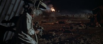 Movie still from “Duck, You Sucker!” (1971), directed by Sergio Leone – An old man is holding a gun in the middle of a field; Wide shot, High angle