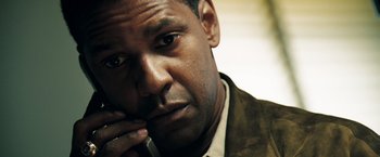 Movie still from “Deja Vu” (2006), directed by Tony Scott – A person holding a cell phone to his ear; Close Up shot, Low angle