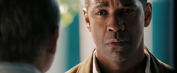 Movie still from “Deja Vu” (2006), directed by Tony Scott – Denzel washington's face as he stares into the camera; Close Up shot, Over the shoulder angle
