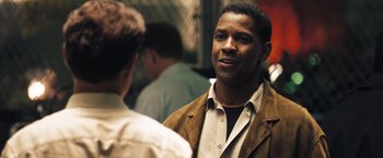 Movie still from “Deja Vu” (2006), directed by Tony Scott – A man standing next to another man wearing a brown jacket; Close Up shot, Over the shoulder angle