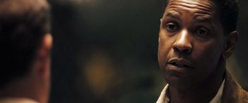 Movie still from “Deja Vu” (2006), directed by Tony Scott – A person looking at the camera; Close Up shot, Over the shoulder angle