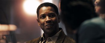 Movie still from “Deja Vu” (2006), directed by Tony Scott – A man in a brown jacket is looking at the camera; Close Up shot, Over the shoulder angle