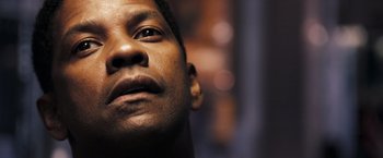 Movie still from “Deja Vu” (2006), directed by Tony Scott – A man's face looking upward; Close Up shot, Low angle