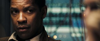 Movie still from “Deja Vu” (2006), directed by Tony Scott – A man's face in front of a building; Close Up shot, Over the shoulder angle