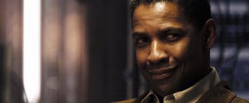 Movie still from “Deja Vu” (2006), directed by Tony Scott – A man's face in a dark room; Close Up shot, Low angle