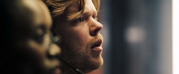 Movie still from “Deja Vu” (2006), directed by Tony Scott – A person with a beard; Close Up shot, Over the shoulder angle