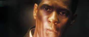 Movie still from “Deja Vu” (2006), directed by Tony Scott – The face of a man with brown eyes; Extreme Close Up shot, Low angle