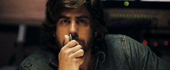 Movie still from “Deja Vu” (2006), directed by Tony Scott – A person holding a cell phone; Close Up shot, Low angle