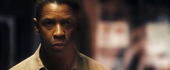 Movie still from “Deja Vu” (2006), directed by Tony Scott – A man's face in a dark room; Close Up shot, Low angle
