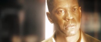 Movie still from “Deja Vu” (2006), directed by Tony Scott – A man's face in the sunlight; Close Up shot, Low angle