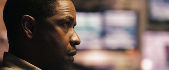 Movie still from “Deja Vu” (2006), directed by Tony Scott – A man's face in front of a television; Close Up shot, Low angle