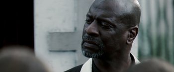Movie still from “Deja Vu” (2006), directed by Tony Scott – An older man with a beard is looking to his left; Close Up shot, Over the shoulder angle