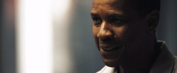 Movie still from “Deja Vu” (2006), directed by Tony Scott – A man's face in a dark room; Close Up shot, Low angle