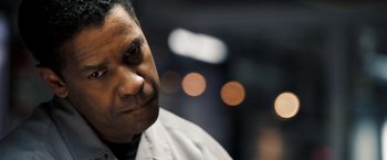 Movie still from “Deja Vu” (2006), directed by Tony Scott – A person wearing a shirt and tie; Close Up shot, Over the shoulder angle