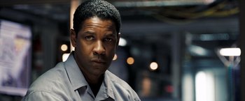 Movie still from “Deja Vu” (2006), directed by Tony Scott – A man in a gray shirt is looking at the camera; Close Up shot, Over the shoulder angle