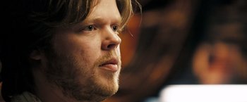 Movie still from “Deja Vu” (2006), directed by Tony Scott – A person with long hair and a beard; Close Up shot, Over the shoulder angle