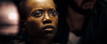 Movie still from “Deja Vu” (2006), directed by Tony Scott – A person wearing glasses; Close Up shot, Low angle