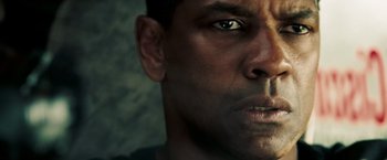 Movie still from “Deja Vu” (2006), directed by Tony Scott – A man's face with a dark background; Close Up shot, Low angle