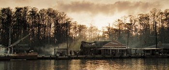 Movie still from “Deja Vu” (2006), directed by Tony Scott – A man standing next to a boat on a body of water; Extreme Wide shot, Low angle
