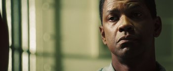 Movie still from “Deja Vu” (2006), directed by Tony Scott – A man's face in front of a building; Close Up shot, Low angle