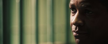 Movie still from “Deja Vu” (2006), directed by Tony Scott – A man's face in front of a green background; Extreme Close Up shot, Over the shoulder angle